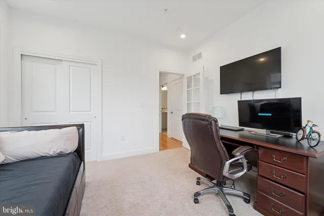 a view of a workspace with furniture and a flat screen tv
