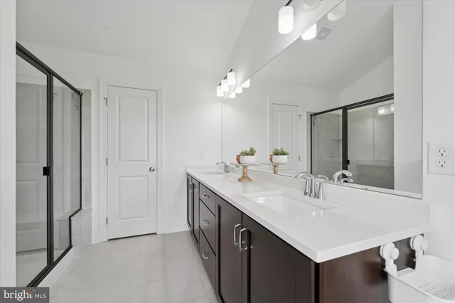 a bathroom with a sink double vanity and a mirror