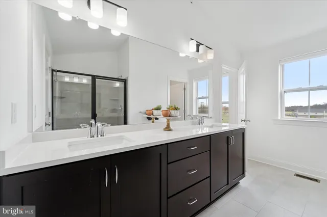 a bedroom with furniture and a chandelier fan