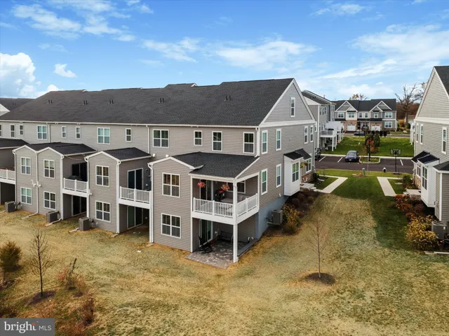 a aerial view of a house with a yard and balcony