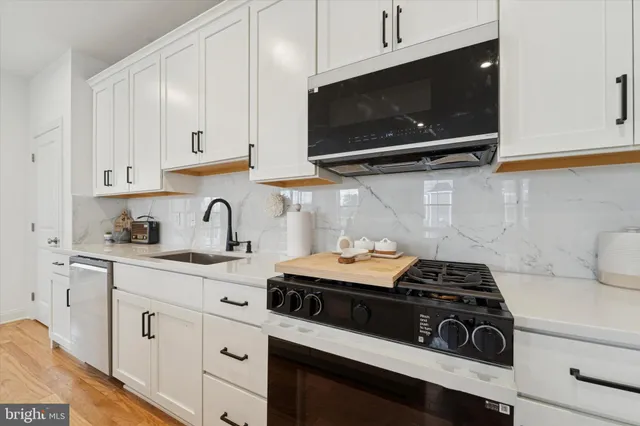 a kitchen with stainless steel appliances a stove a microwave and cabinets