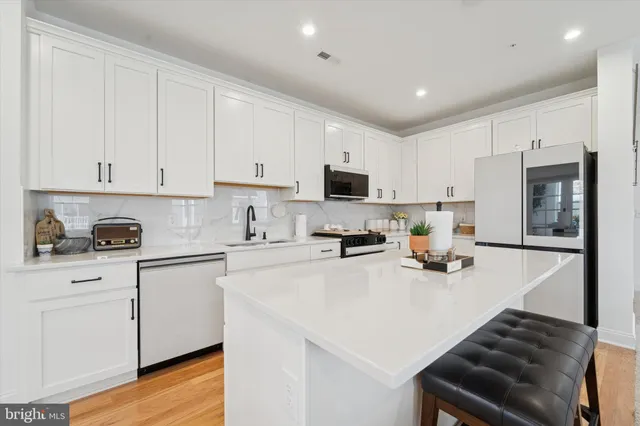a kitchen with cabinets and wooden floor