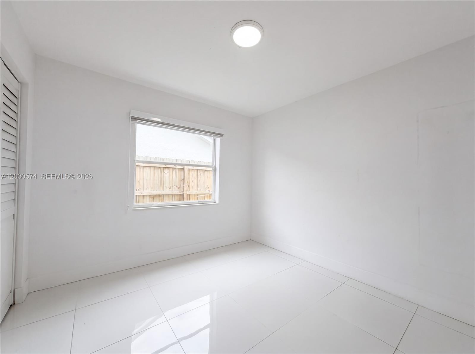 16571 Southwest 145th Avenue Miami, FL 33177 - Photo 16 of 25 an empty room with a window