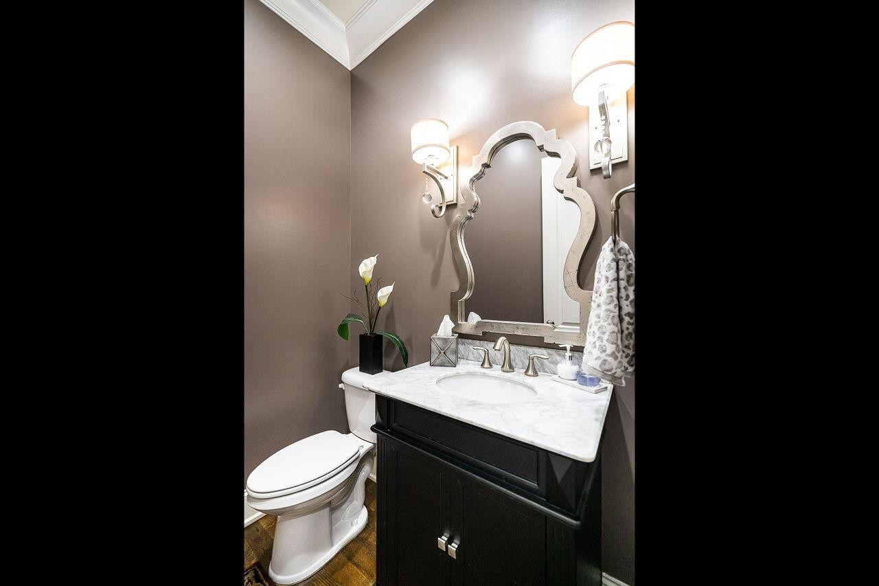 8401 Bournemouth Drive Raleigh, NC 27615 - Photo 22 of 41 Half-Bath with raised vanity, marble top, custom mirror and hardwood floors. Half-Bath