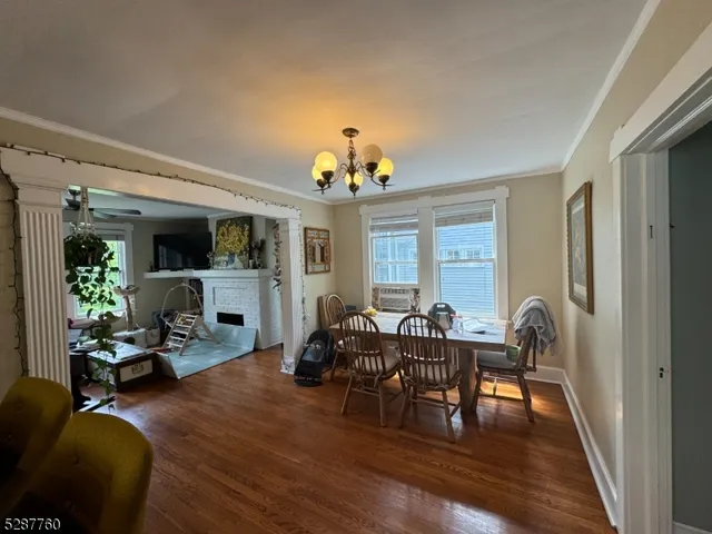 a view of a dining room with furniture wooden floor and chandelier