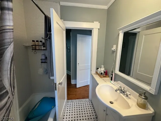 a living room with furniture stairs and a window