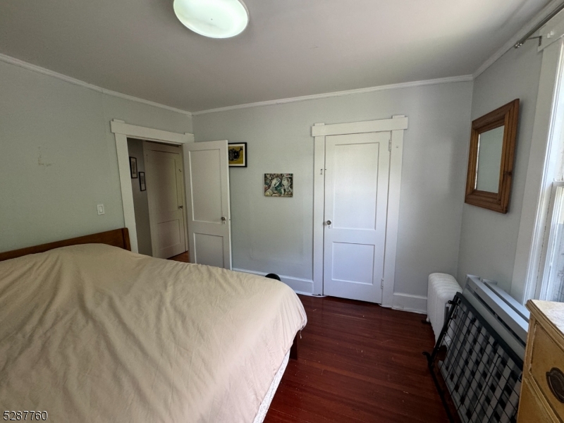 226 Park Street, Unit 2 Montclair, NJ 07042 - Photo 18 of 24 a bedroom with a bed and a chandelier