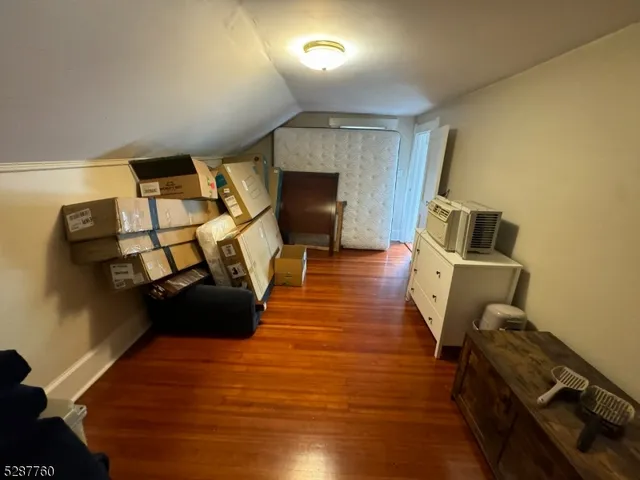 a room with gym equipment and wooden floor