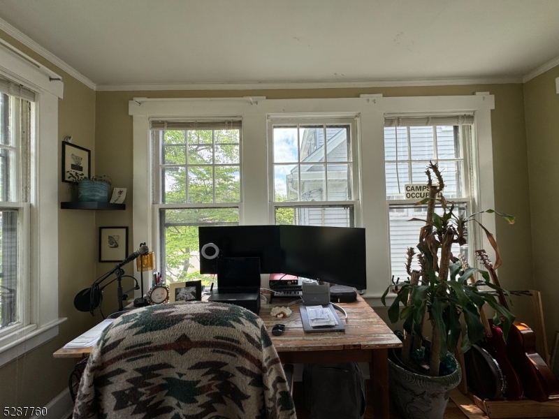 226 Park Street, Unit 2 Montclair, NJ 07042 - Photo 5 of 24 a bedroom with a bed a computer on a desk and a potted plant