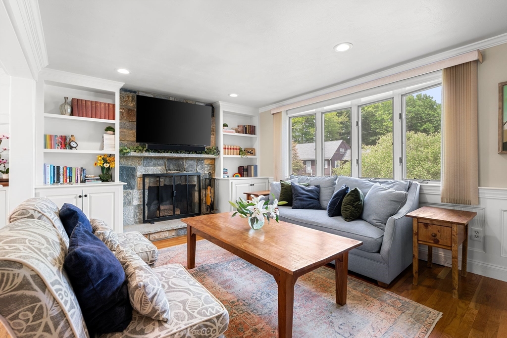 35 Spallus Road Stoughton, MA 02072 - Photo 7 of 39 a living room with furniture a flat screen tv and a fireplace