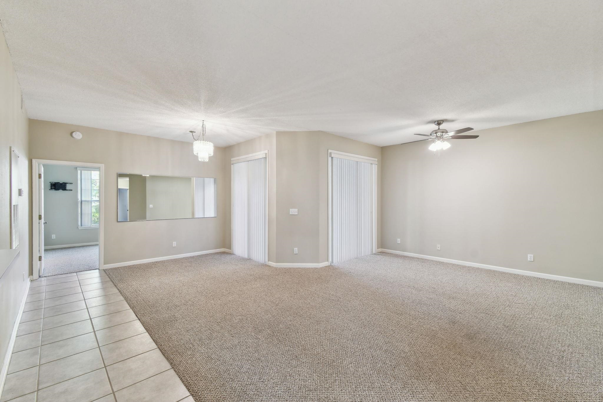 202 Augusta Circle St. Augustine, FL 32086 - Photo 11 of 35 a view of a big room with a chandelier fan and windows