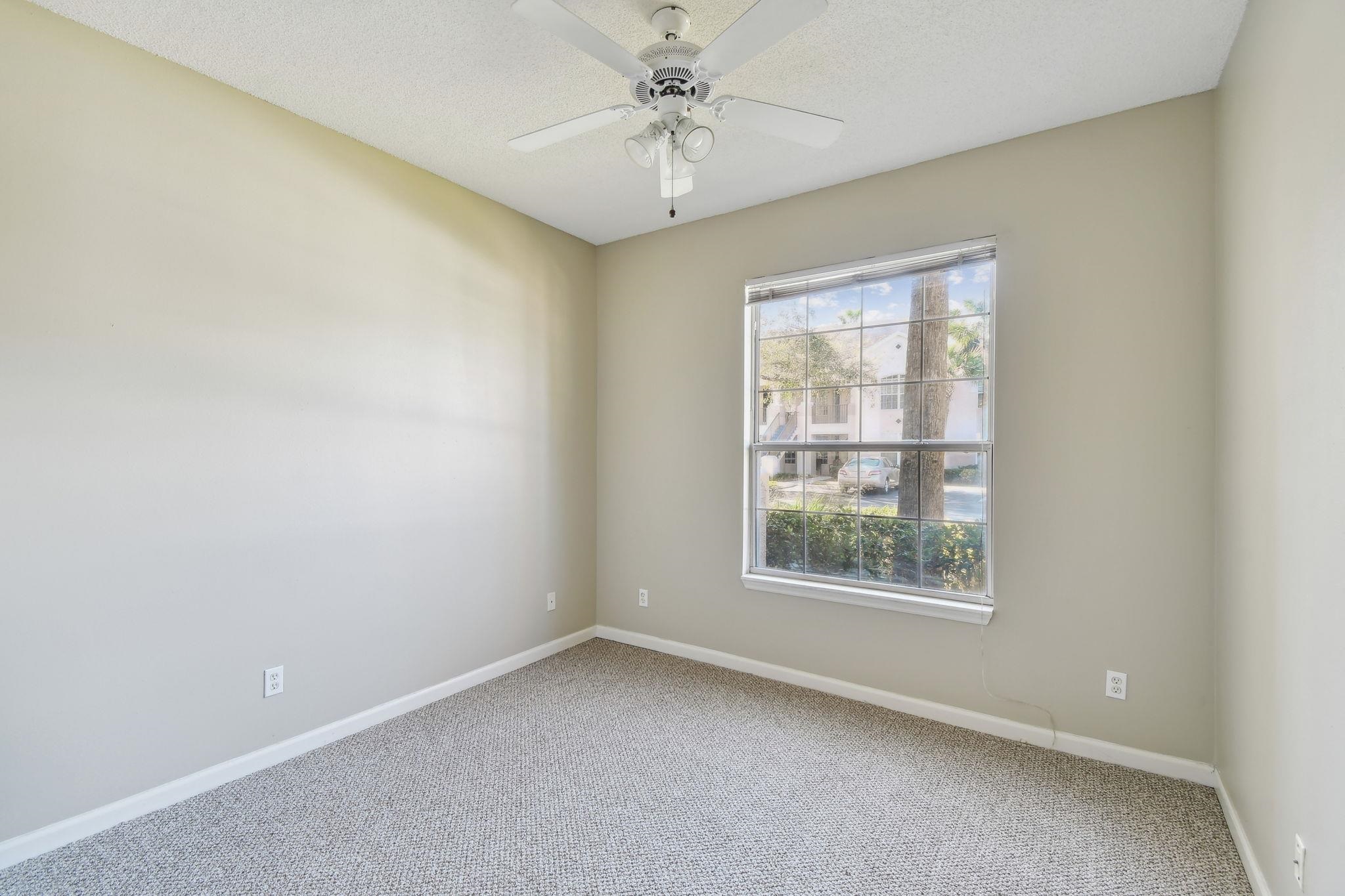 202 Augusta Circle St. Augustine, FL 32086 - Photo 16 of 35 an empty room with a window and a ceiling fan