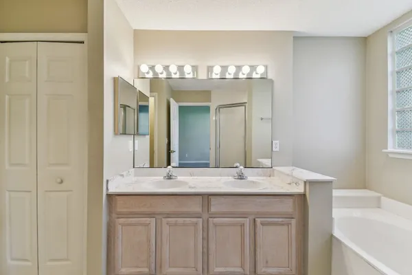 a bathroom with a bathtub and a shower