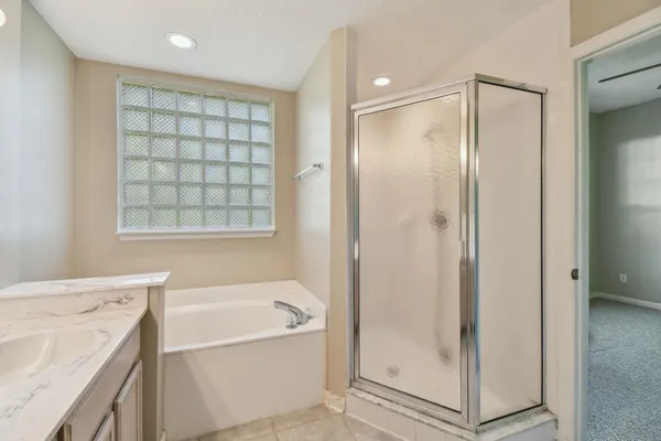a view of a bathroom with a shower and a door