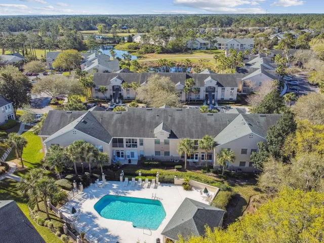 an aerial view of residential houses with outdoor space