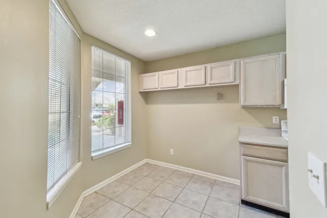 a view of an empty room with a kitchen