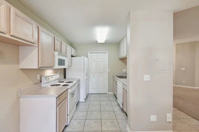 a kitchen with stainless steel appliances granite countertop a refrigerator and a stove
