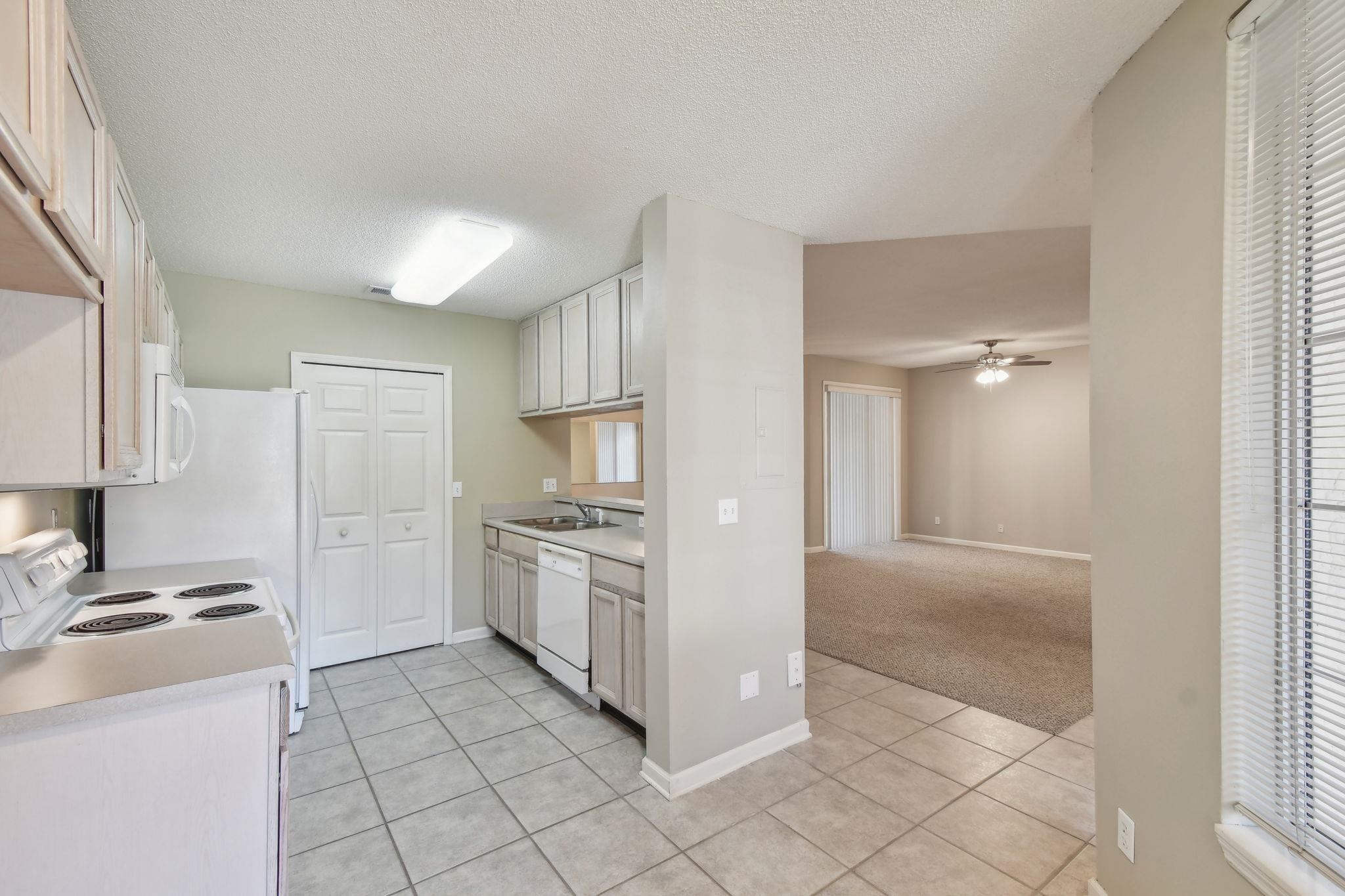 202 Augusta Circle St. Augustine, FL 32086 - Photo 6 of 35 a kitchen with stainless steel appliances granite countertop a stove a sink and a refrigerator