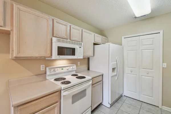 a white stove top oven sitting inside of a kitchen