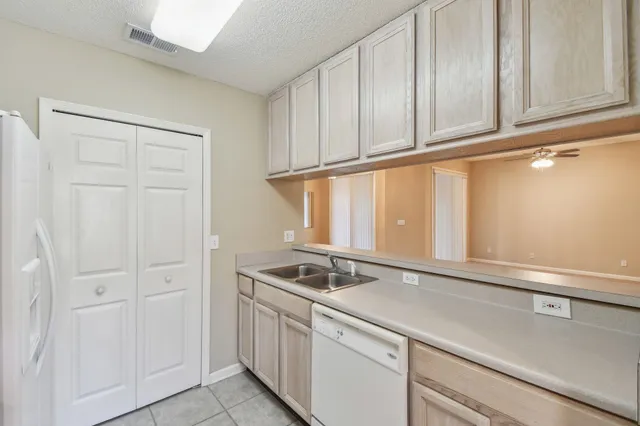 a kitchen with granite countertop white cabinets and a sink