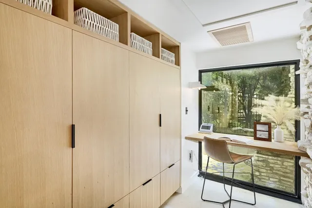 a view of a porch with furniture and floor to ceiling window