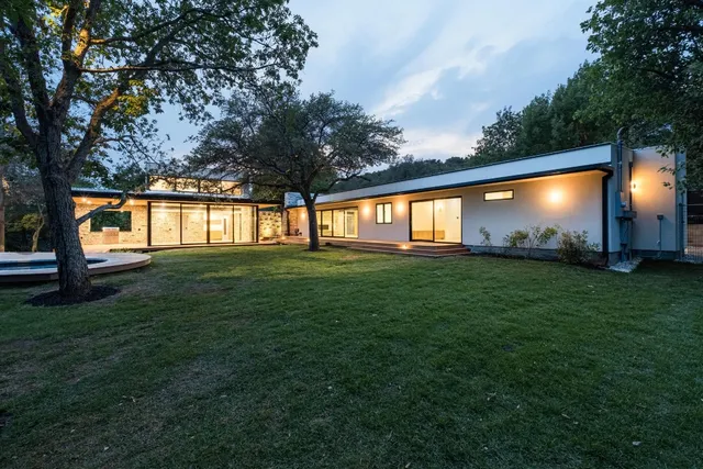 a backyard of a house with lots of green space and garden