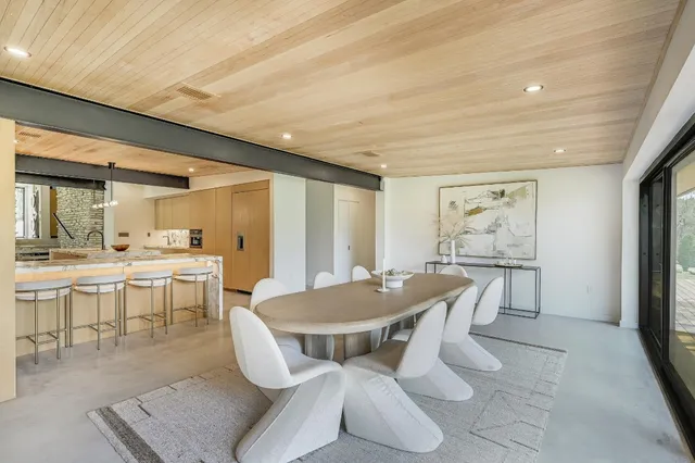 a view of a dining room with furniture and a chandelier