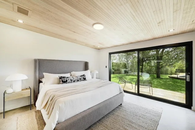 a bedroom with a large bed and a large window