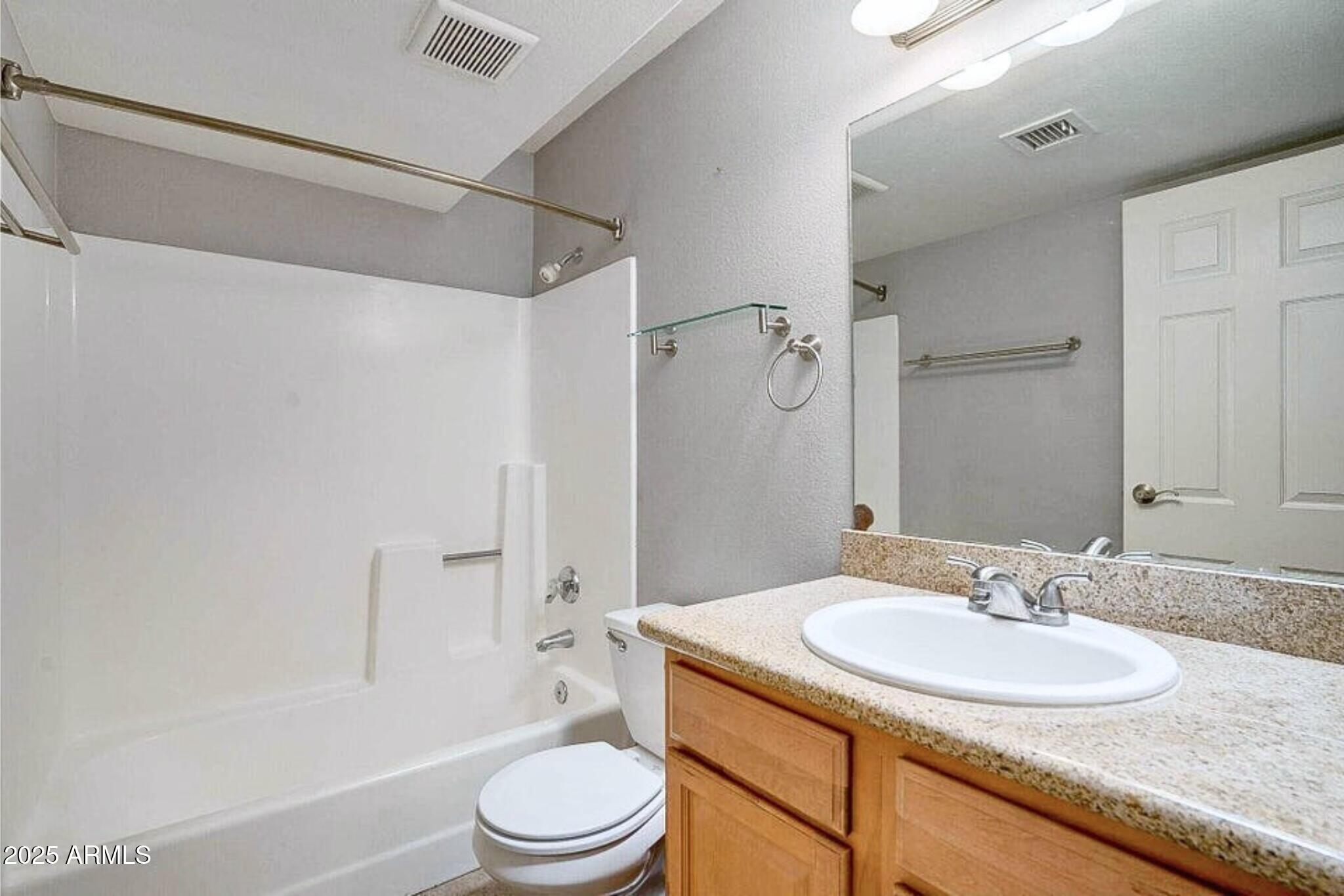885 North Granite Reef Road, Unit 63 Scottsdale, AZ 85257 - Photo 14 of 23 a bathroom with a granite countertop sink toilet and shower