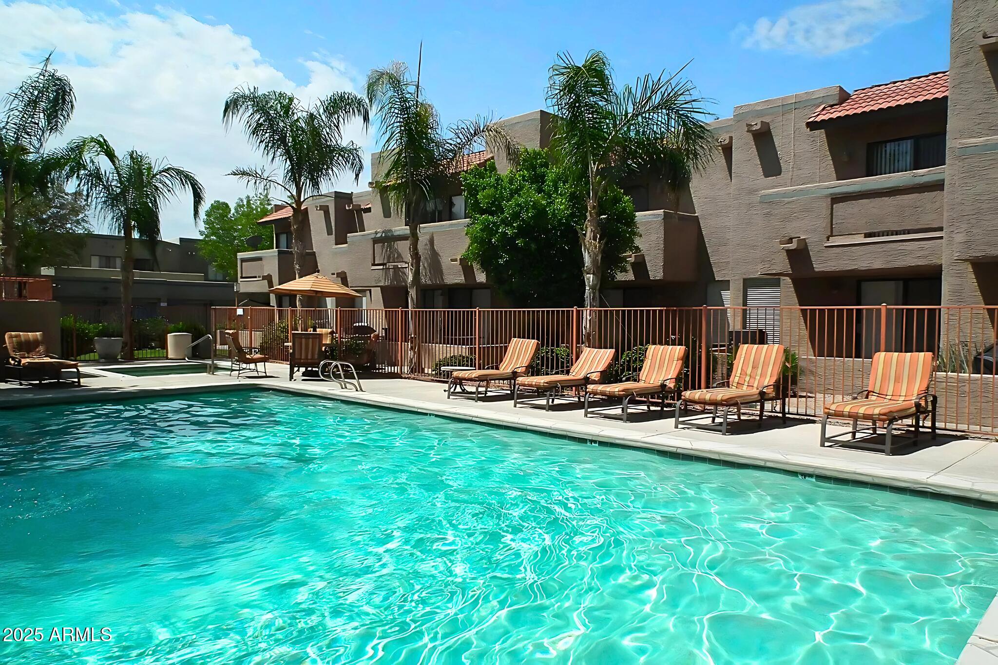 885 North Granite Reef Road, Unit 63 Scottsdale, AZ 85257 - Photo 21 of 23 a view of a swimming pool with a table and chairs