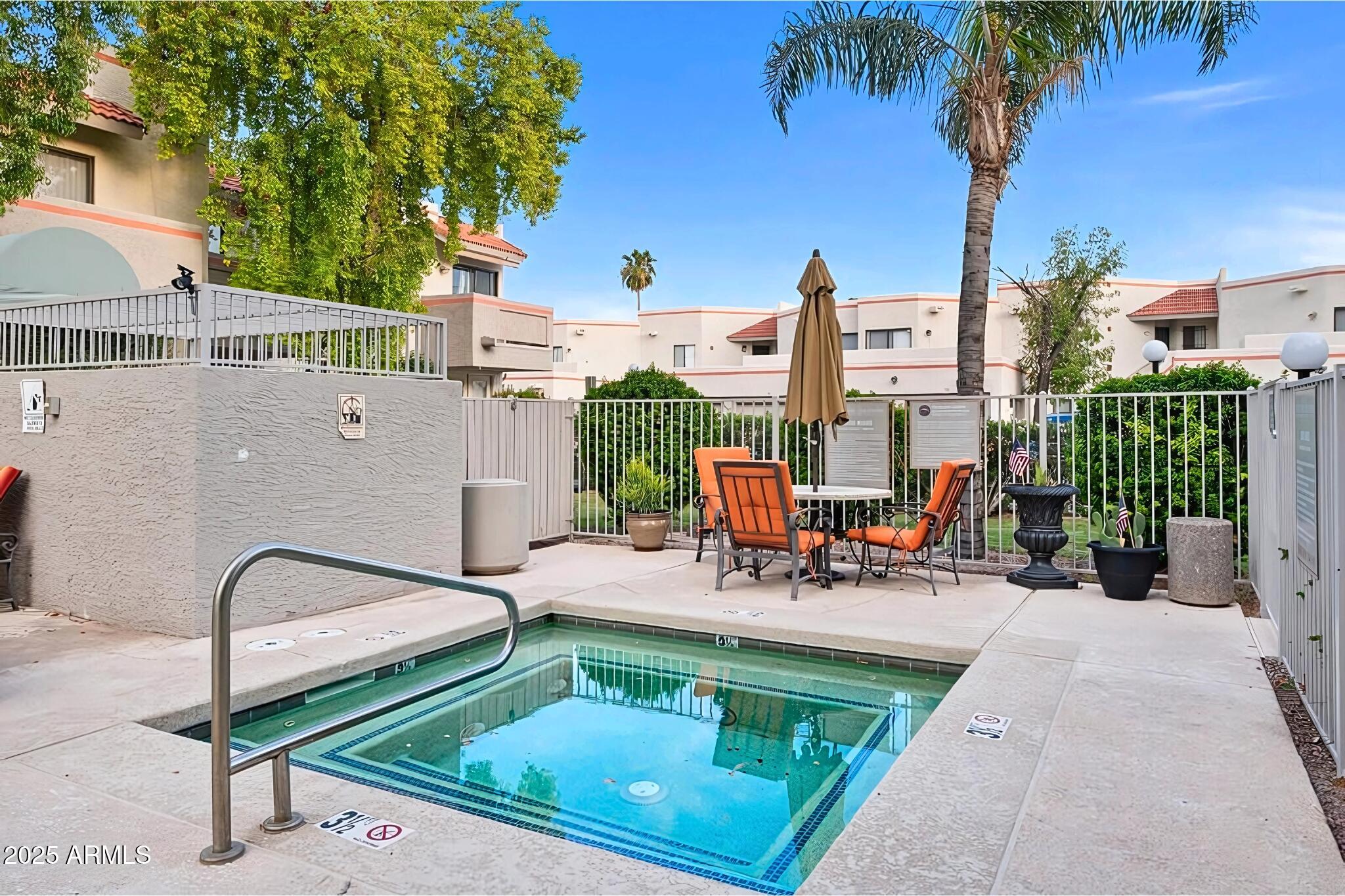885 North Granite Reef Road, Unit 63 Scottsdale, AZ 85257 - Photo 22 of 23 a view of a patio with a table and chairs