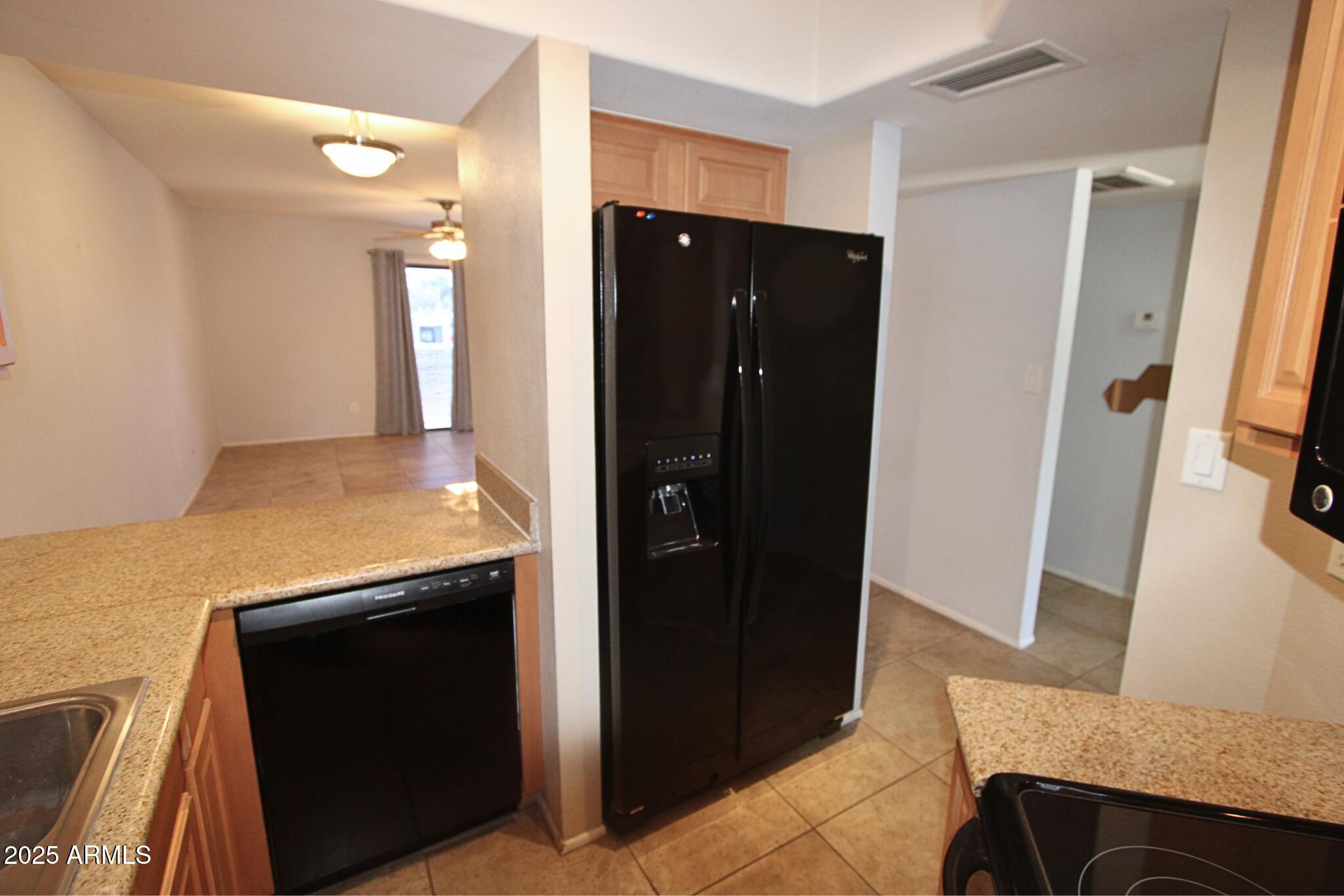 885 North Granite Reef Road, Unit 63 Scottsdale, AZ 85257 - Photo 6 of 23 a view of a kitchen from the hallway
