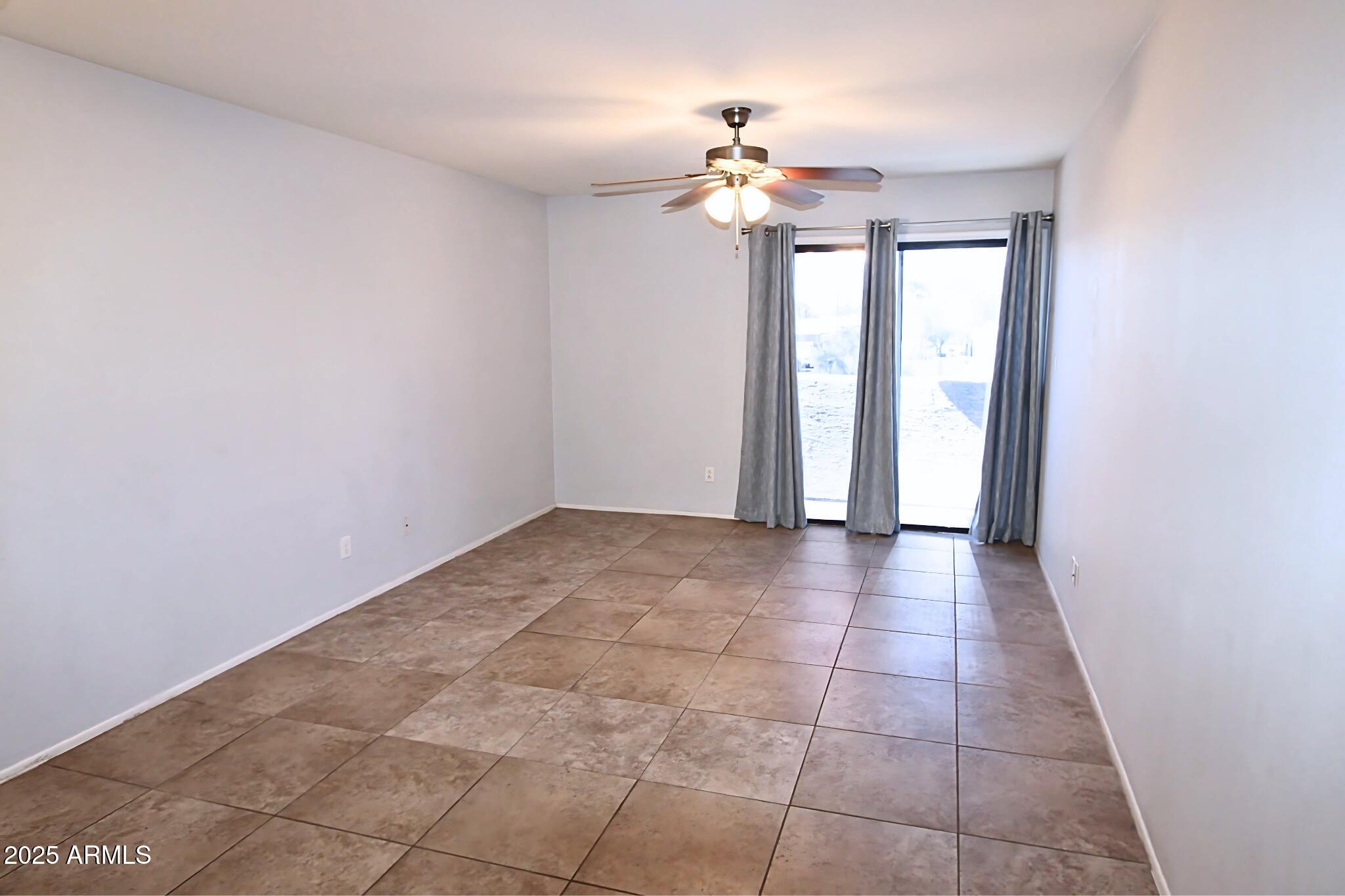 885 North Granite Reef Road, Unit 63 Scottsdale, AZ 85257 - Photo 7 of 23 a view of an empty room with a chandelier fan