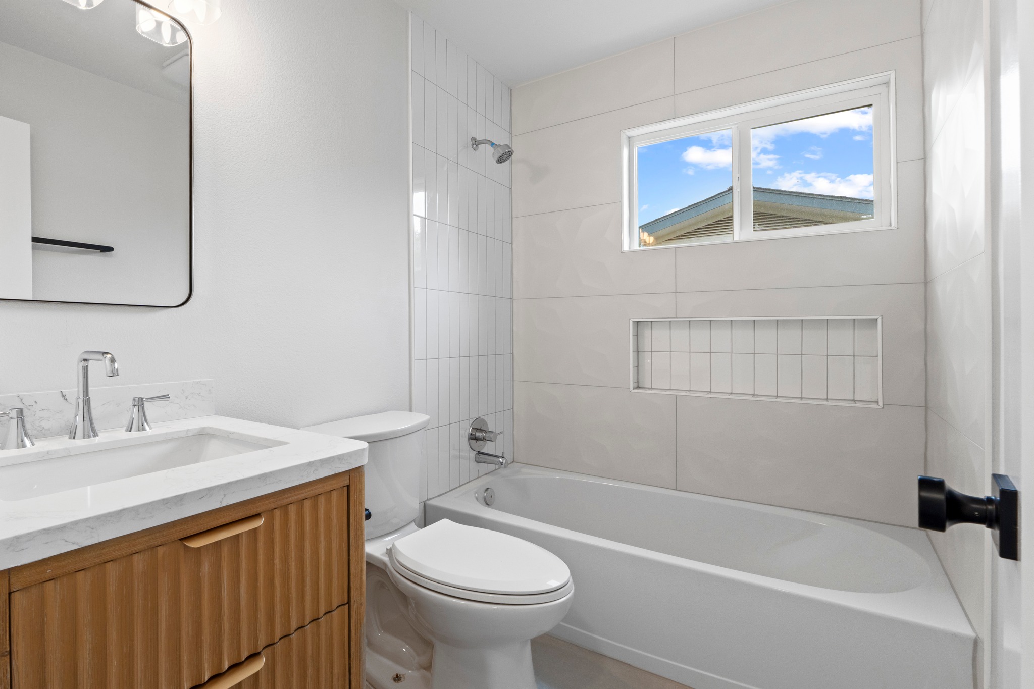 1608 Springer Lane Austin, TX 78758 - Photo 20 of 35 Bathroom featuring a wood-finish vanity with a white countertop, a rectangular undermount sink, and chrome fixtures