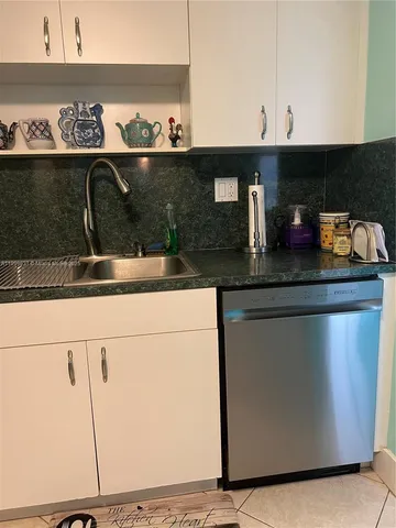 a kitchen with a sink and cabinets
