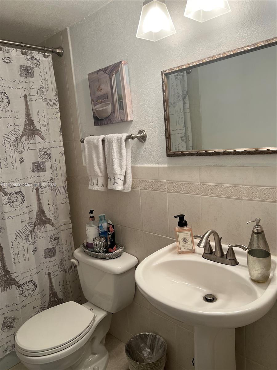 8335 Southwest 72nd Avenue, Unit 212D Miami, FL 33143 - Photo 14 of 31 a bathroom with a sink and a mirror