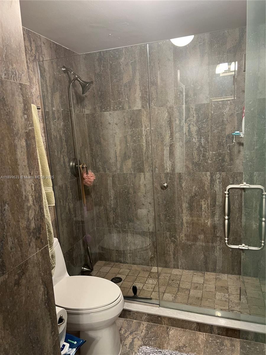 8335 Southwest 72nd Avenue, Unit 212D Miami, FL 33143 - Photo 19 of 31 a bathroom with a shower and a toilet