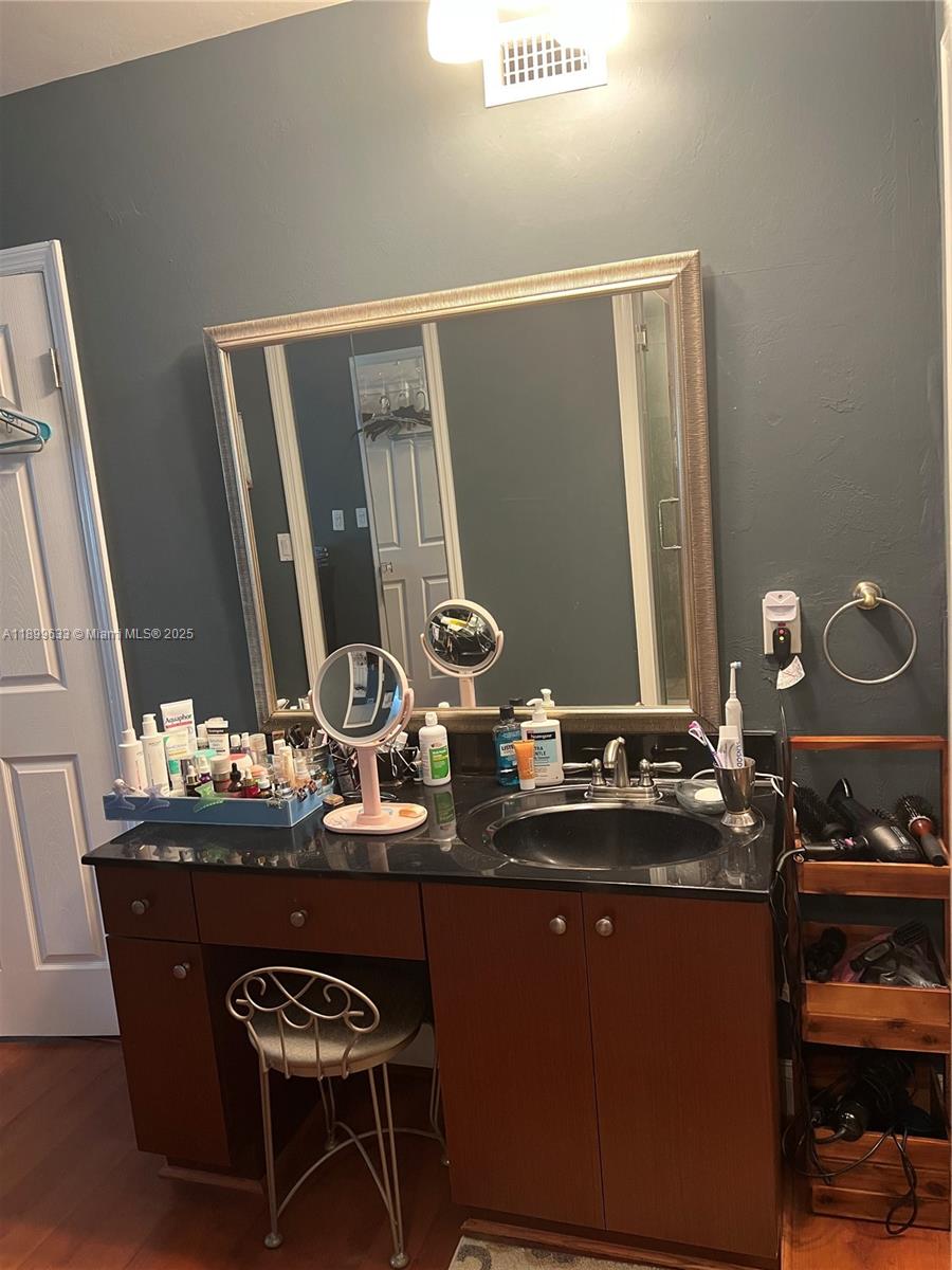 8335 Southwest 72nd Avenue, Unit 212D Miami, FL 33143 - Photo 21 of 31 a dining room with table chairs and wooden floor