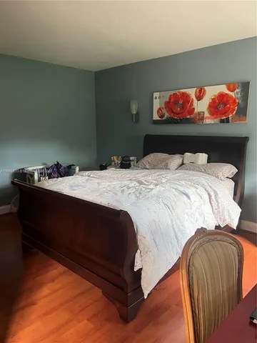 a bedroom with a bed and mirror