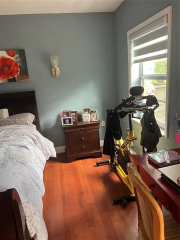 a bedroom with bed and a window