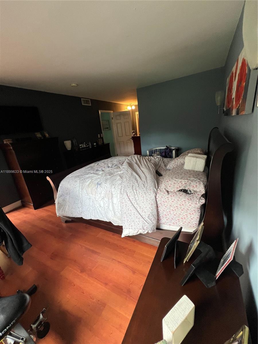 8335 Southwest 72nd Avenue, Unit 212D Miami, FL 33143 - Photo 24 of 31 a bedroom with a bed and mirror