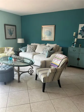 a living room with furniture and wall paintings