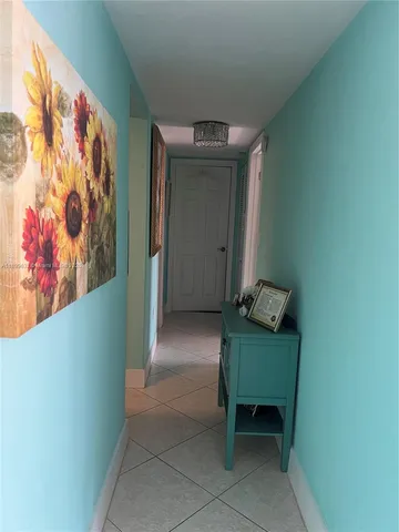 a living room with furniture a rug and a flat screen tv