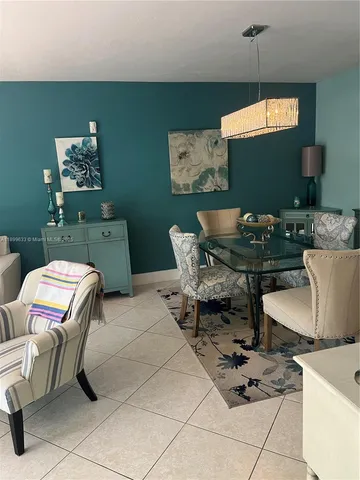 a living room with furniture and a mirror