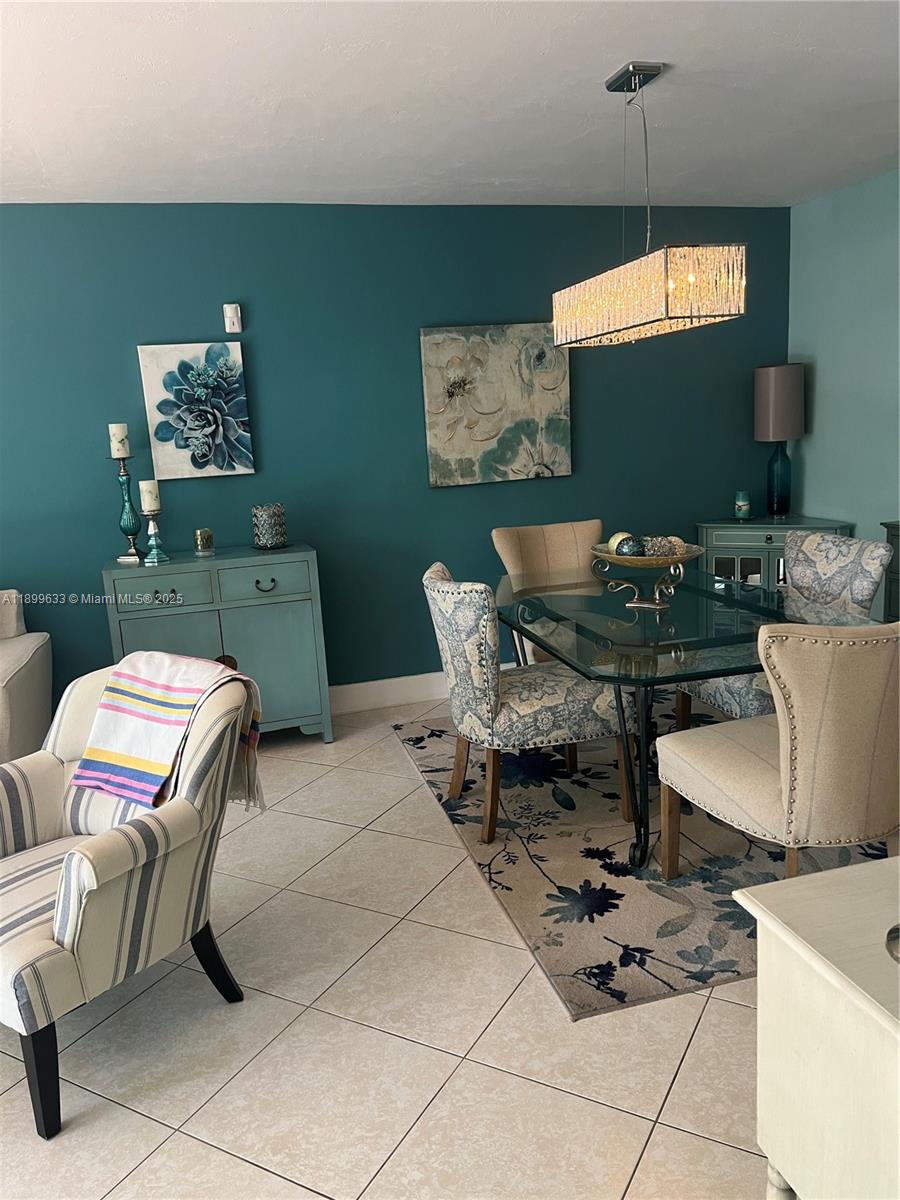 8335 Southwest 72nd Avenue, Unit 212D Miami, FL 33143 - Photo 6 of 31 a living room with furniture a rug and a flat screen tv