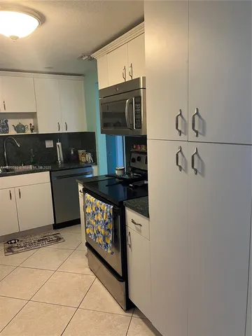 a kitchen with a stove and a microwave