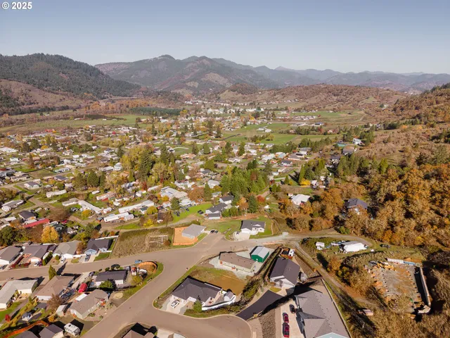 an aerial view of residential house and sandy dunes