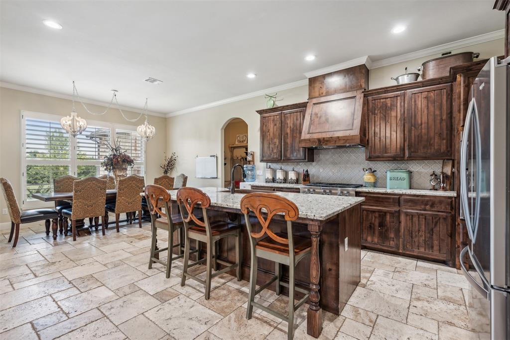 4180 North Smith Road Fate, TX 75087 - Photo 8 of 27 a large kitchen with lots of furniture a sink appliances and cabinets