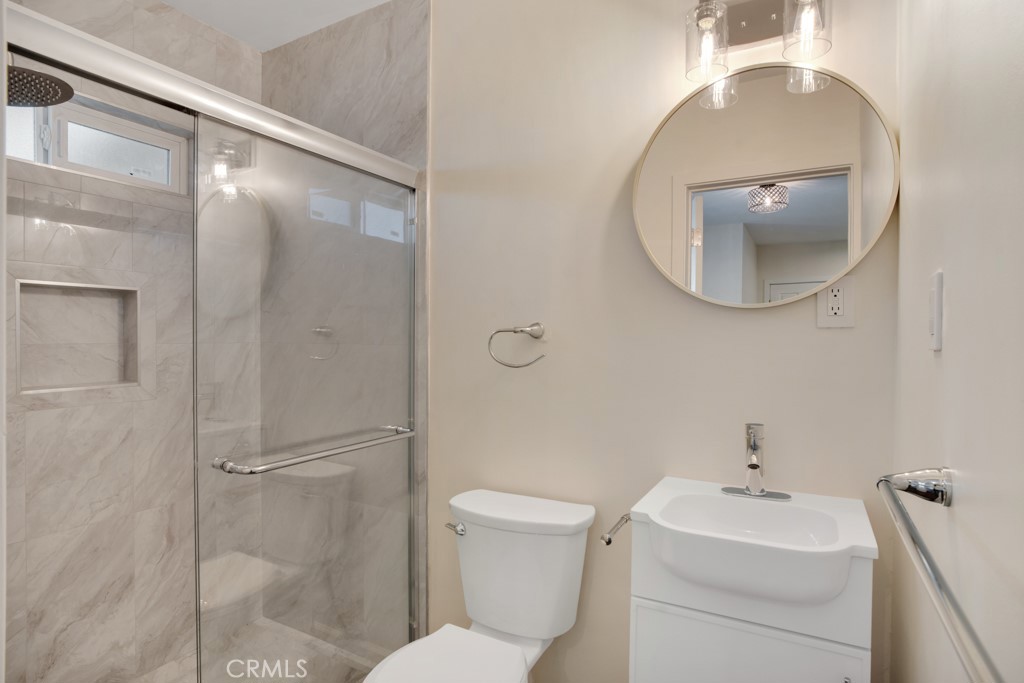 7635 Fallbrook Avenue West Hills, CA 91304 - Photo 12 of 26 a bathroom with a toilet a sink and a mirror