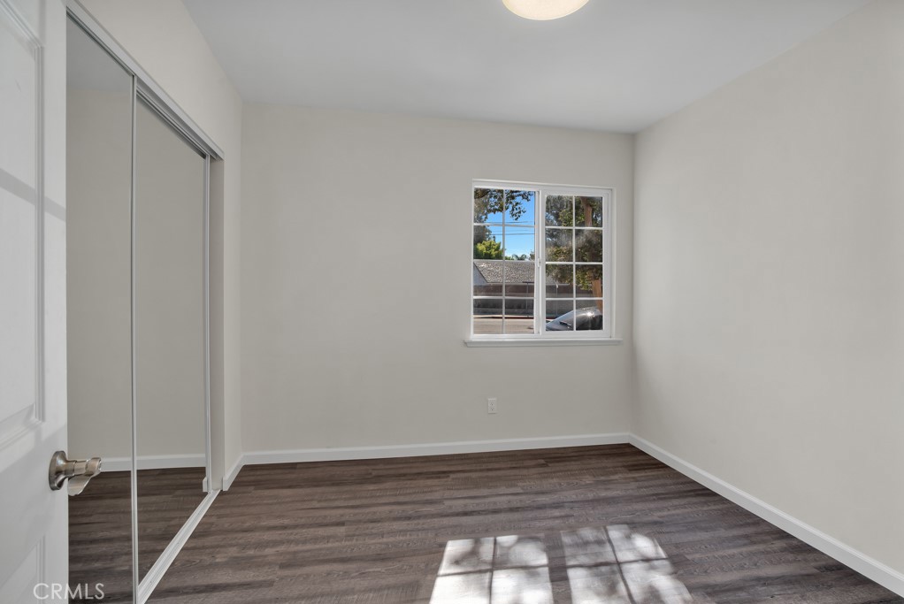 7635 Fallbrook Avenue West Hills, CA 91304 - Photo 13 of 26 a view of an empty room with wooden floor and a window